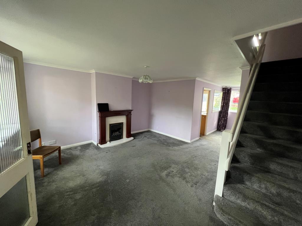 Lot: 23 - THREE-BEDROOM HOUSE FOR IMPROVEMENT - Open plan living room with stairs to first floor